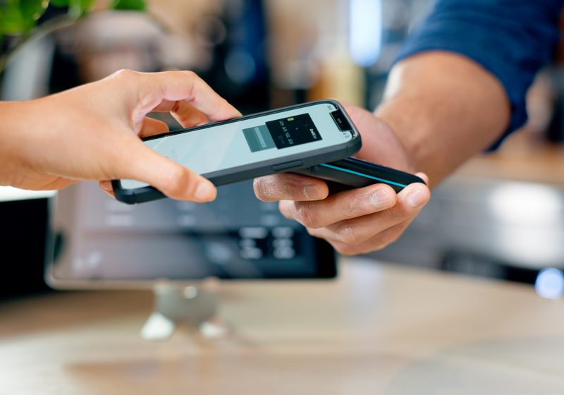 Customer paying cashier using phone
