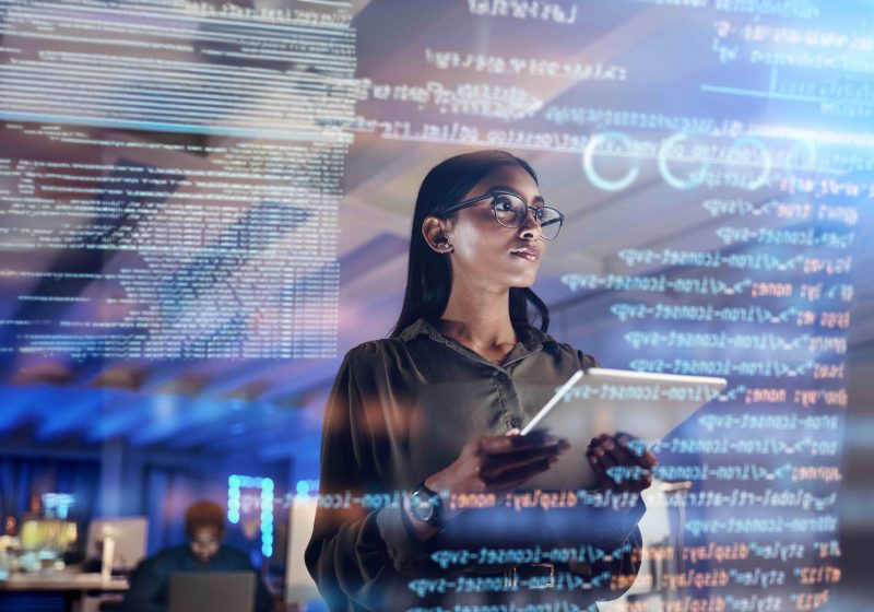 Woman looking at clear screen with lines of code