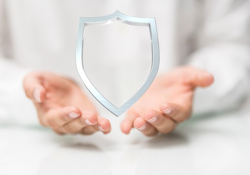 Hands cupping a shield