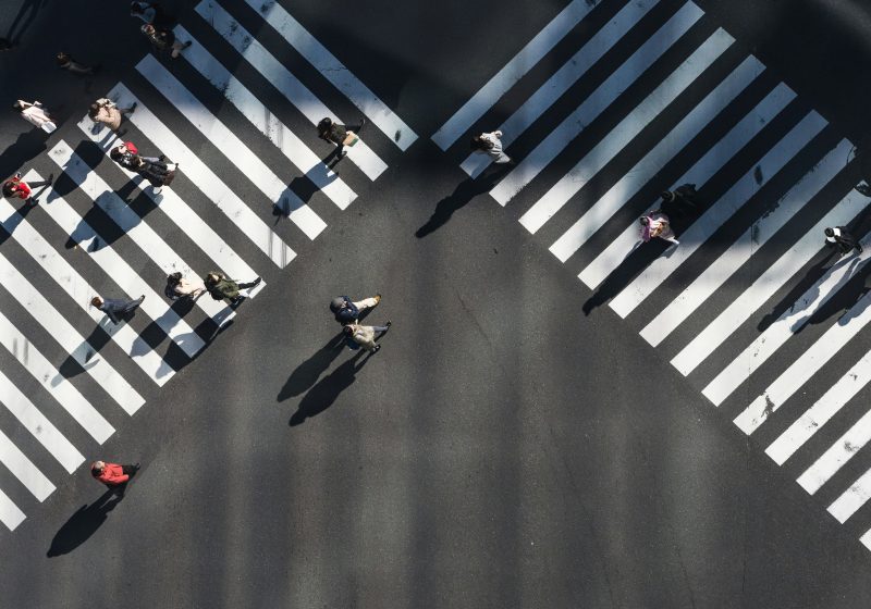 Birdseye view of people walking along crossroads