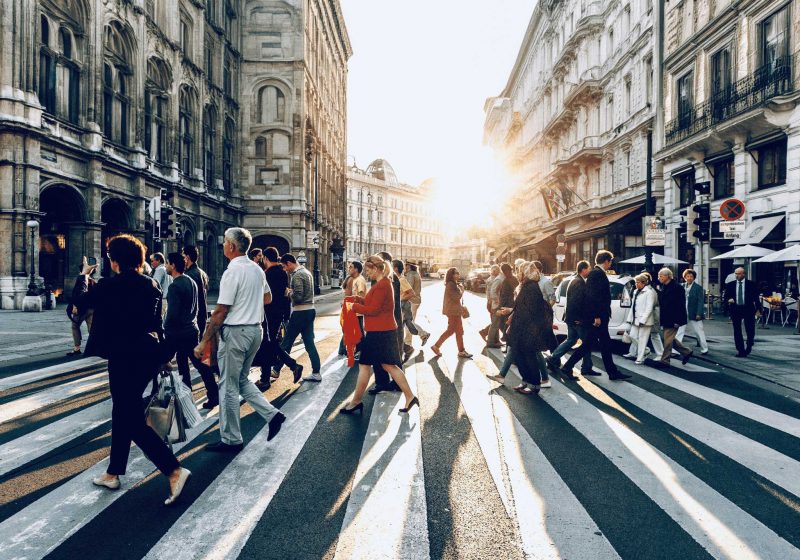 Image of people crossing a busy street in Europe